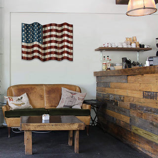 Waving American Flag - Corrugated Metal Wall Art hanging above leather couch in rustic cafe setting with wood and metal decor