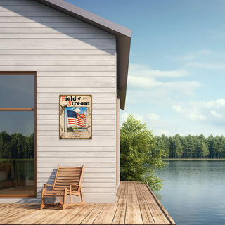 Field & Stream Cover July 1942 - Wood & Metal Wall Art hangs on exterior wall by lake with wooden chair on deck